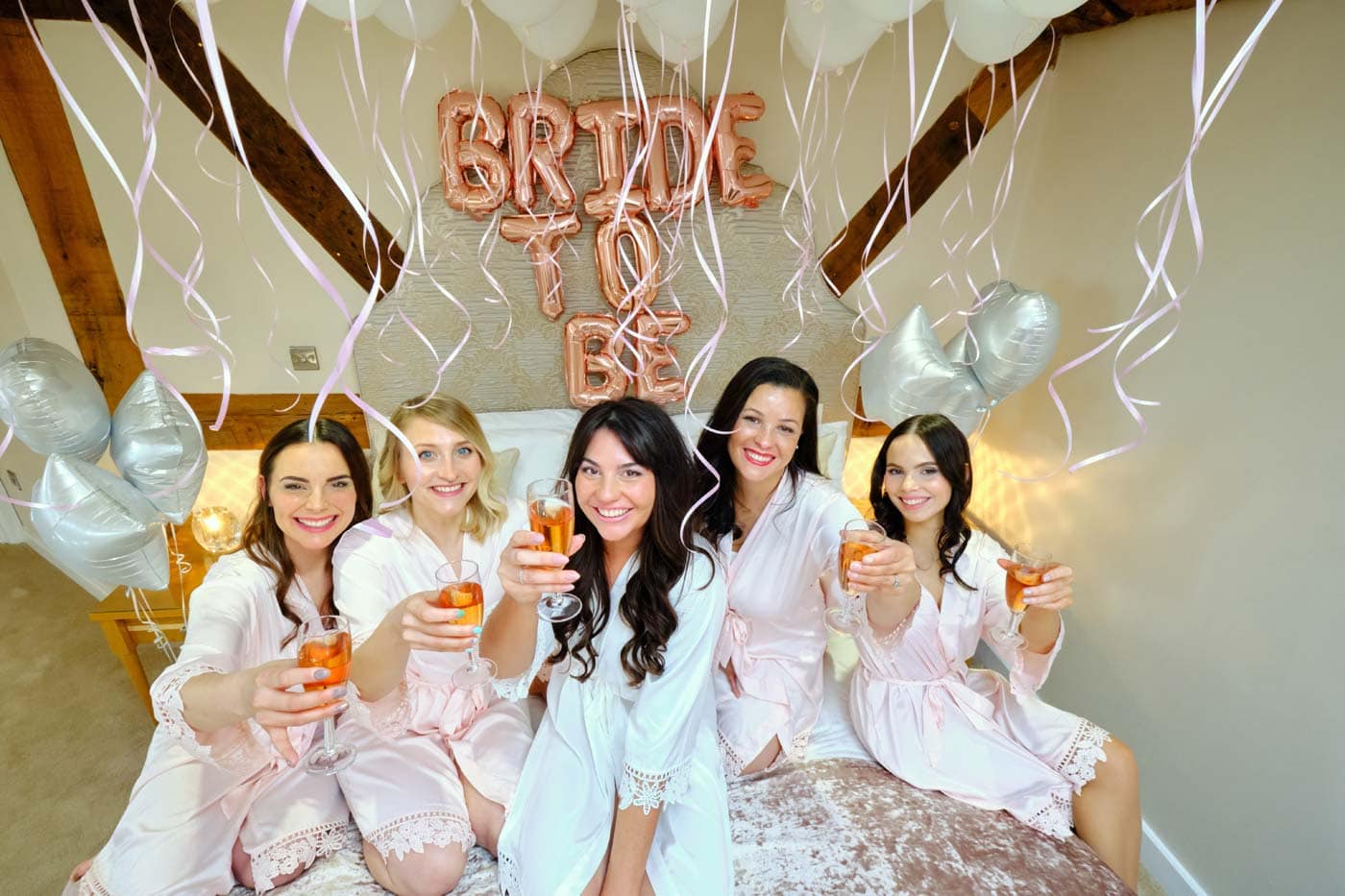 Happy bride with her 4 maids in the bank house penthouse suite in the morning of her wedding