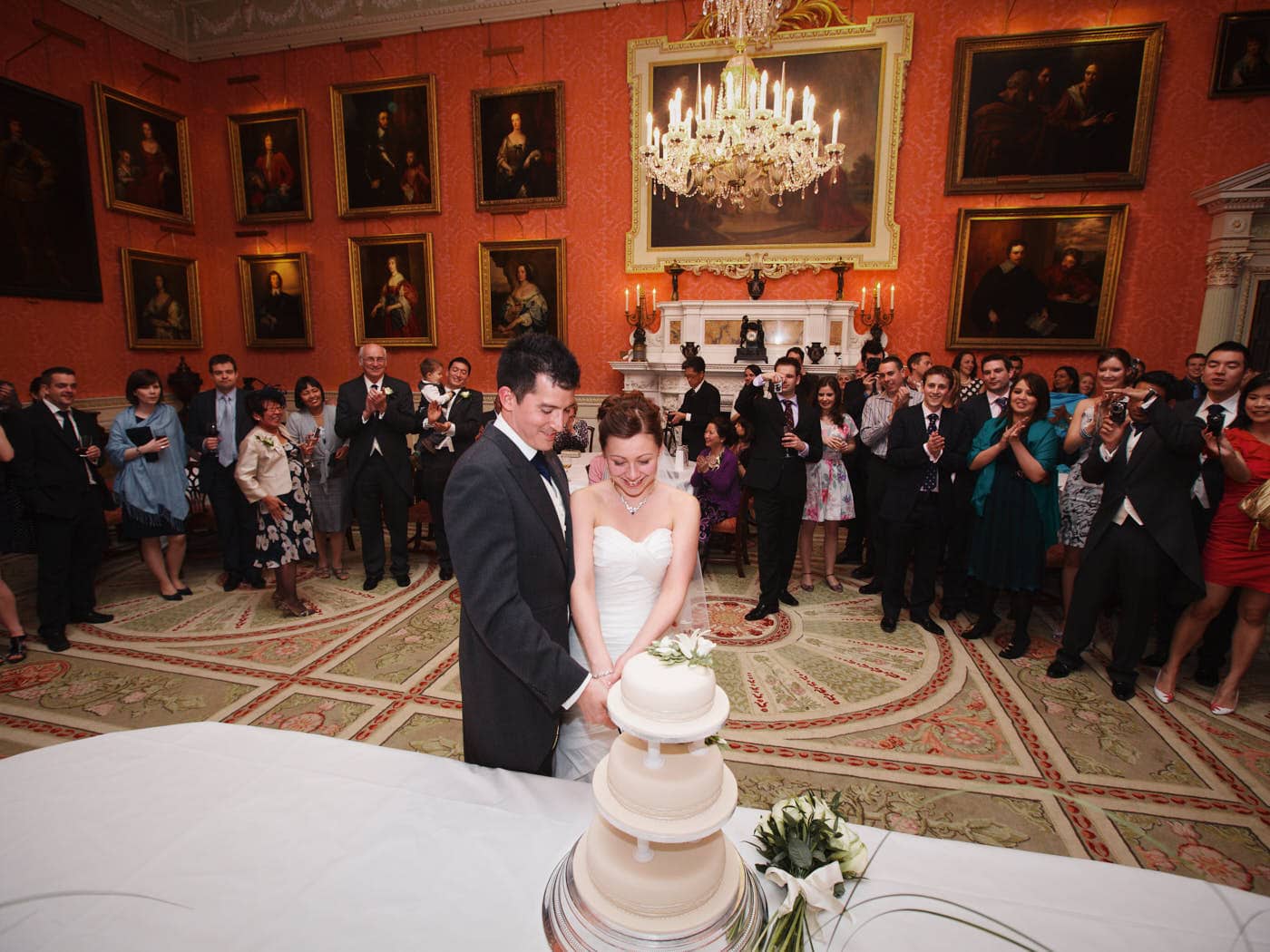 Bride and groom cutting the cake at Weston Park