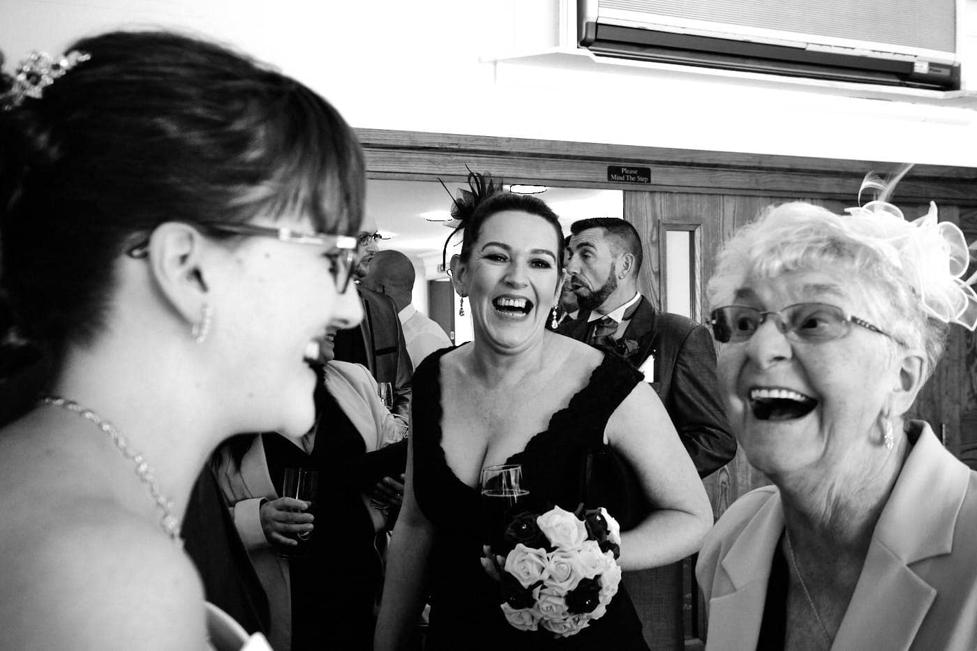 Guests laughing with bride during receiving line