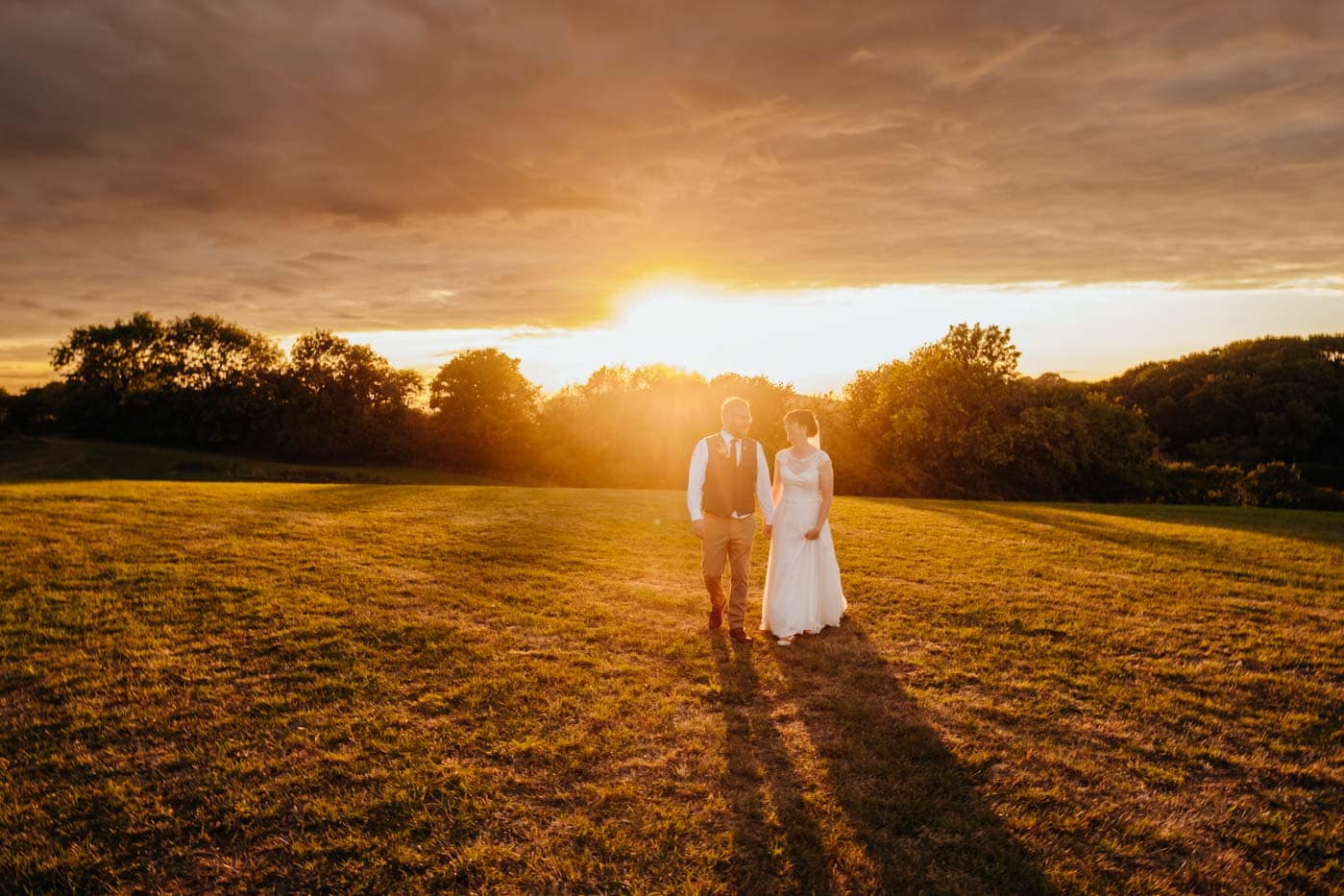 Bride and groom during golden hour after their outdoor wedding ceremony